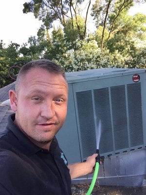 Owner Ryyan Murphy cools down overworked evaporator coils on an air conditioner in Modesto