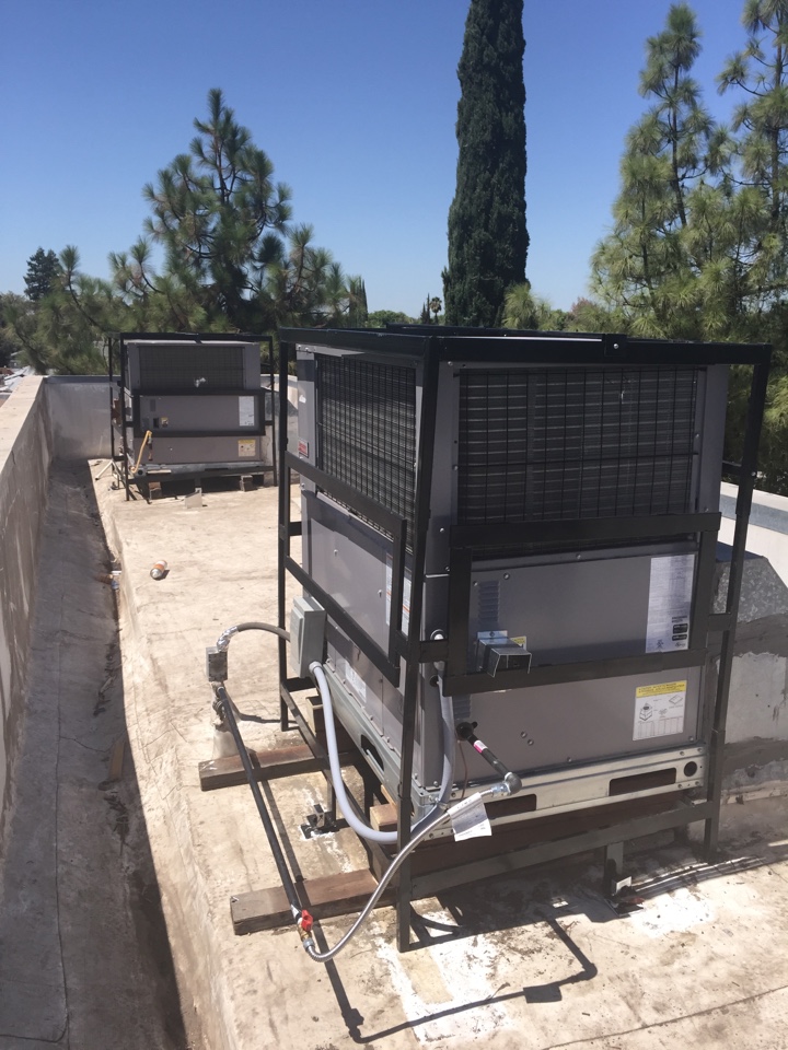 rooftop packaged commercial air conditioner installation with theft-proof cages